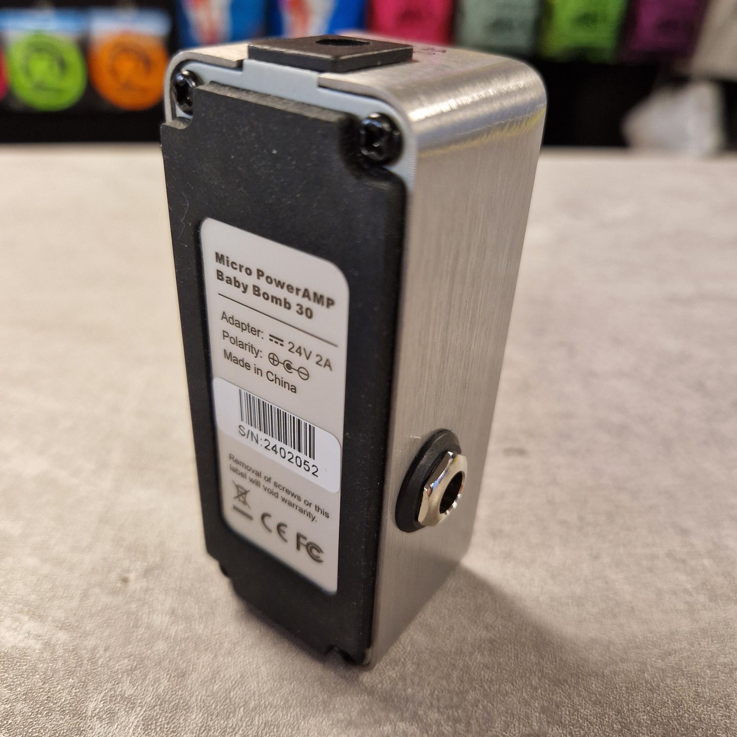 Pre-Owned Mooer Small electronic device with a label on a textured surface