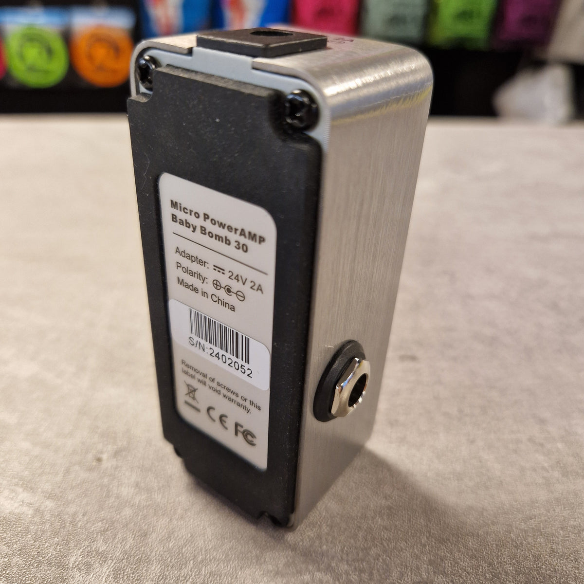 Pre-Owned Mooer Small electronic device with a label on a textured surface