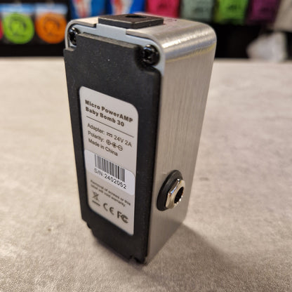 Pre-Owned Mooer Small electronic device with a label on a textured surface