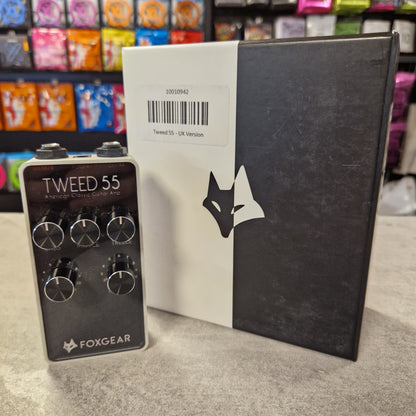 Pre-Owned FoxGear Black and white box with a brand logo, featuring a guitar effects pedal on a textured surface.