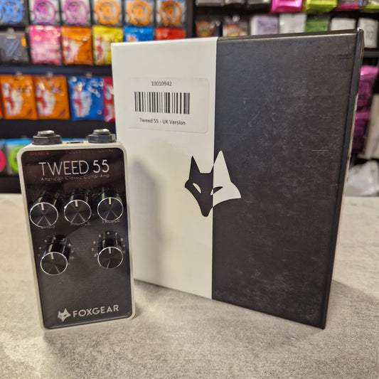 Pre-Owned FoxGear Black and white box with a brand logo, featuring a guitar effects pedal on a textured surface.