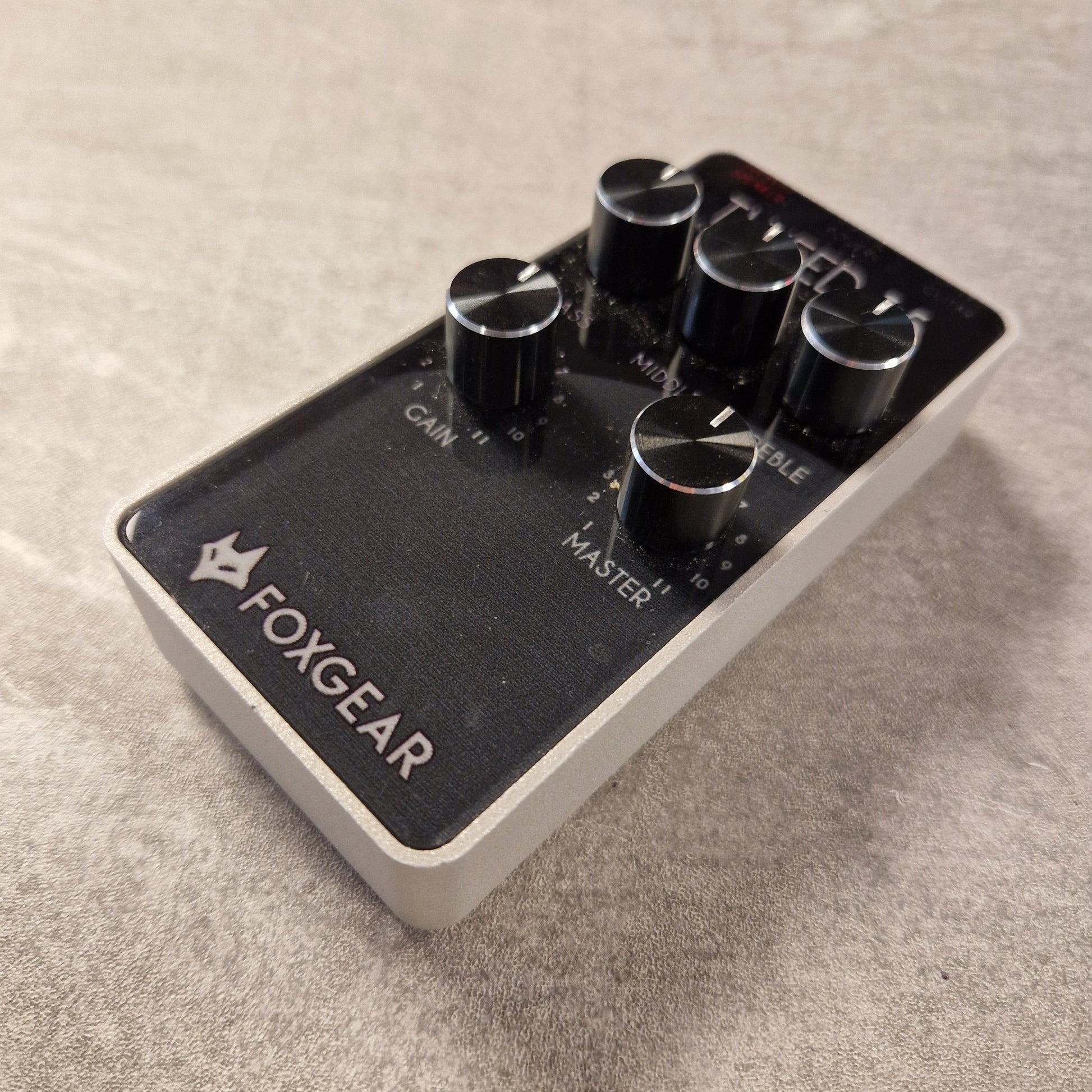 Pre-Owned FoxGear Guitar effects pedal with 'FOXGEAR' branding on a textured surface
