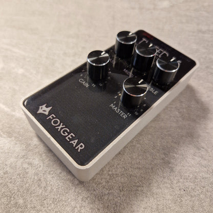 Pre-Owned FoxGear Guitar effects pedal with 'FOXGEAR' branding on a textured surface