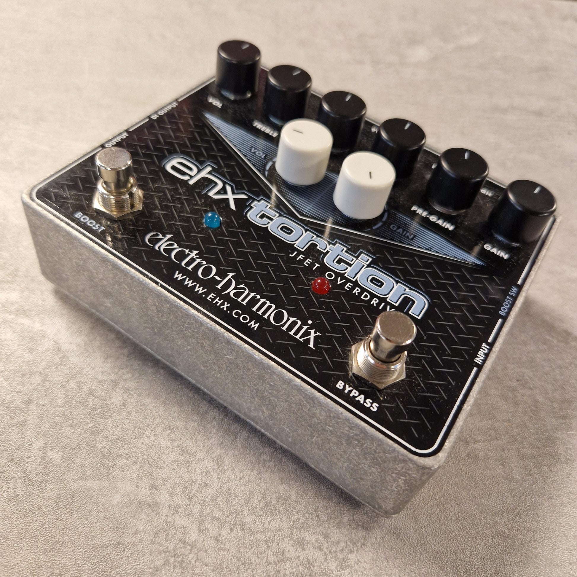 Pre-Owned Electro-Harmonix guitar effects pedal on a grey surface