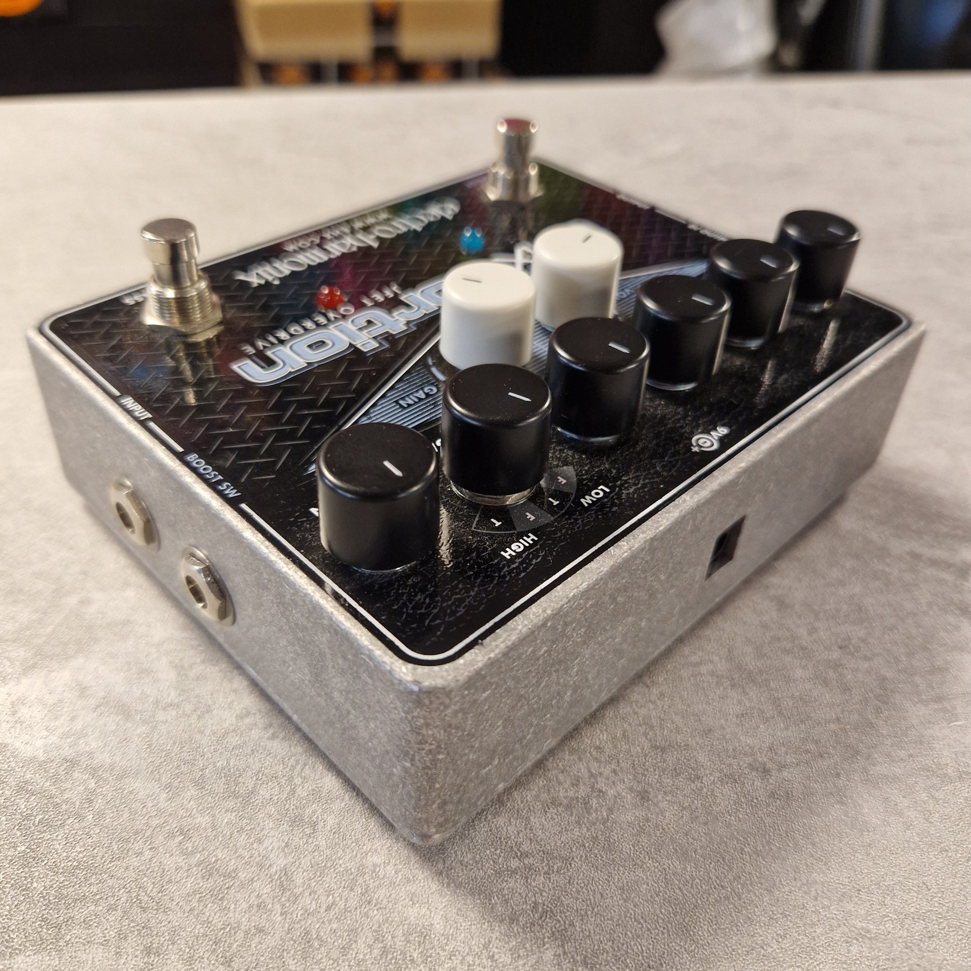 Pre-Owned Electro-Harmonix Guitar effects pedal with knobs and switches on a textured surface