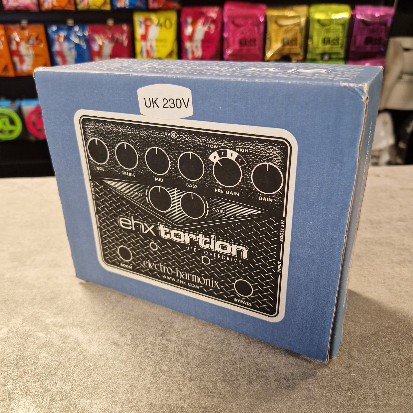 Pre-Owned Electro-Harmonix Blue box with electronic device illustration and 'ehxtortion' branding on a textured surface.
