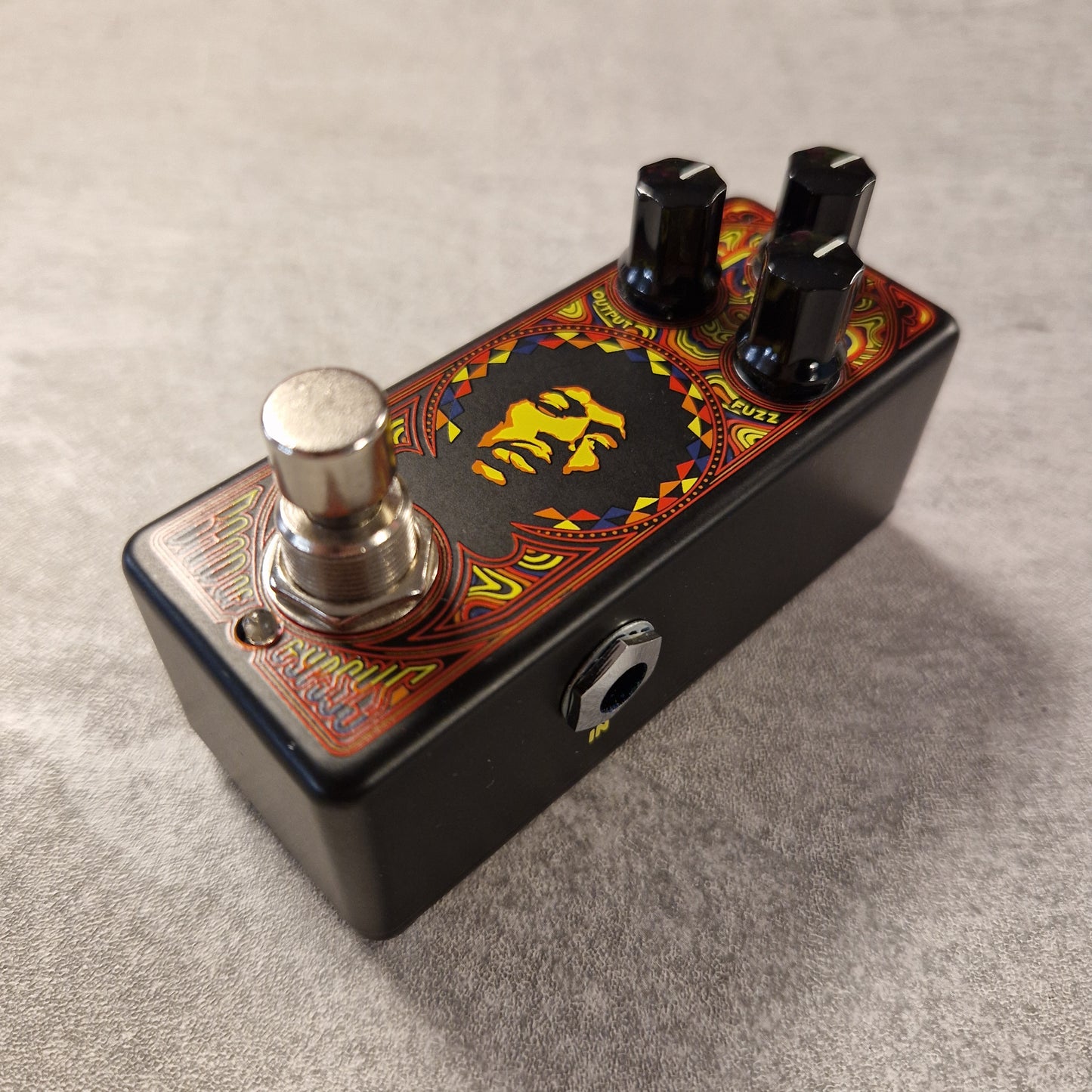 Pre-Owned Dunlop Guitar effects pedal with colourful design on a grey surface