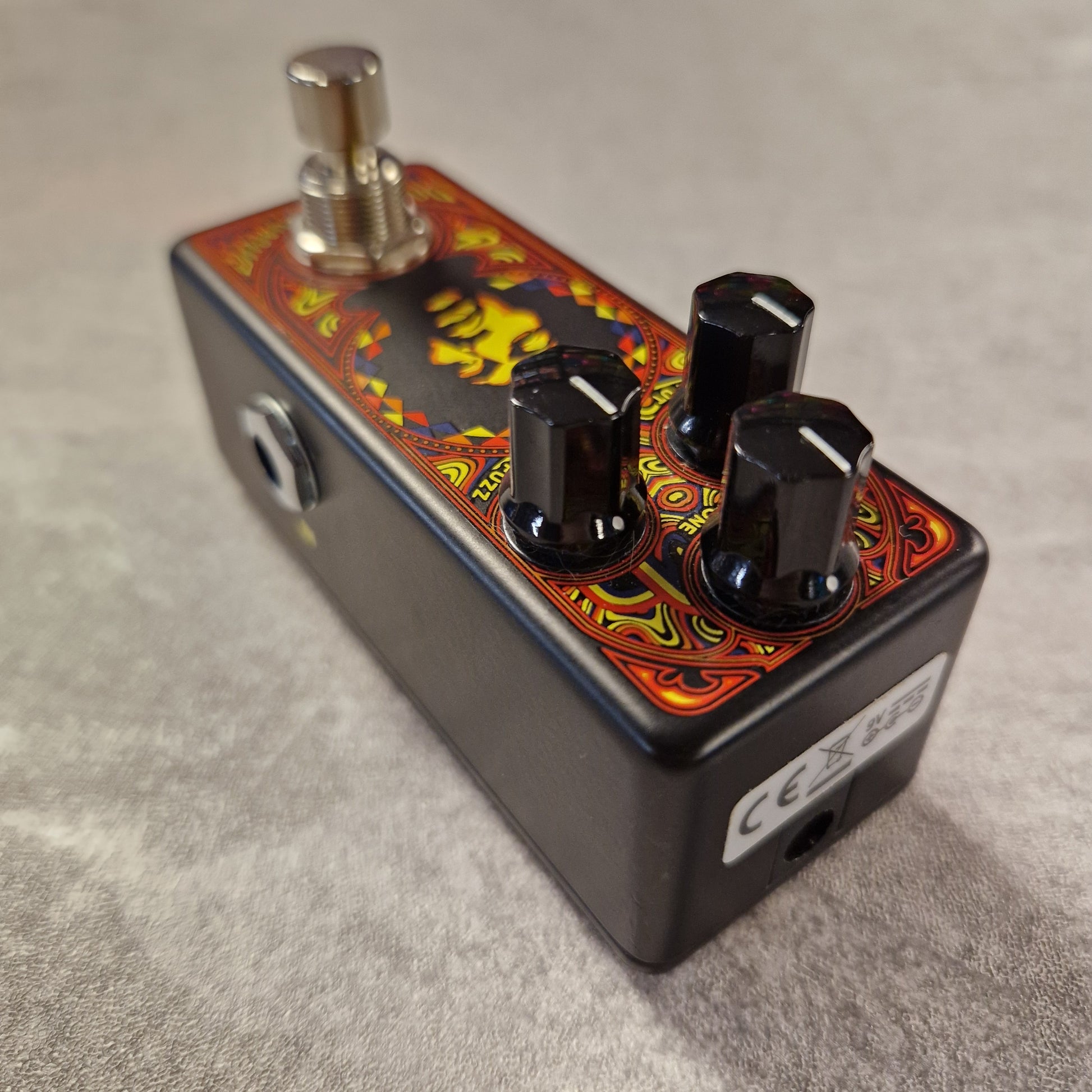 Pre-Owned Dunlop Guitar effects pedal with colourful design on a grey surface