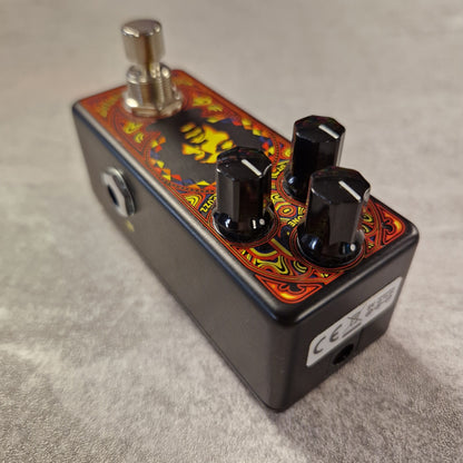 Pre-Owned Dunlop Guitar effects pedal with colourful design on a grey surface