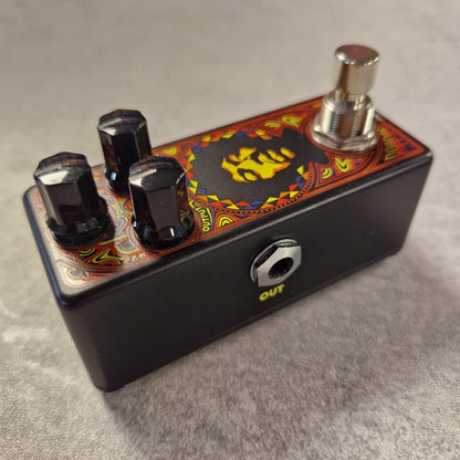 Pre-Owned Dunlop Guitar effects pedal with colourful design on a grey surface