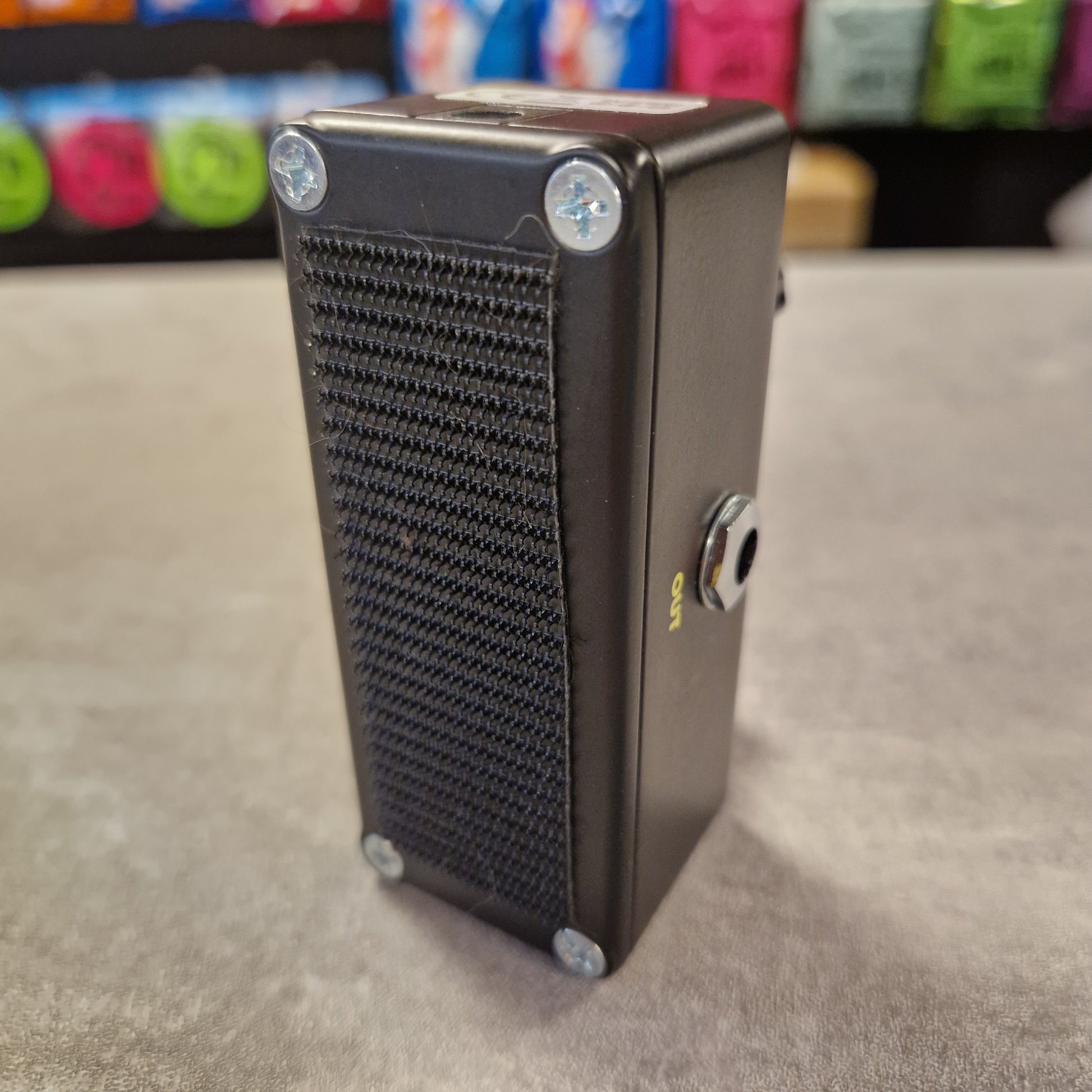 Pre-Owned Dunlop Black rectangular object with textured surface on a grey background