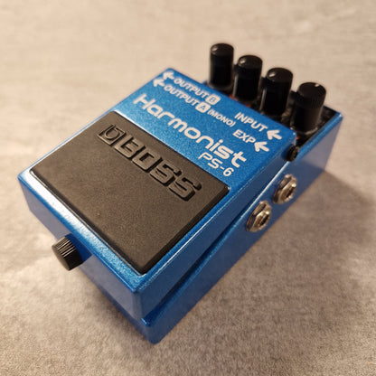 Pre-Owned Boss Blue and black guitar effects pedal on a beige surface