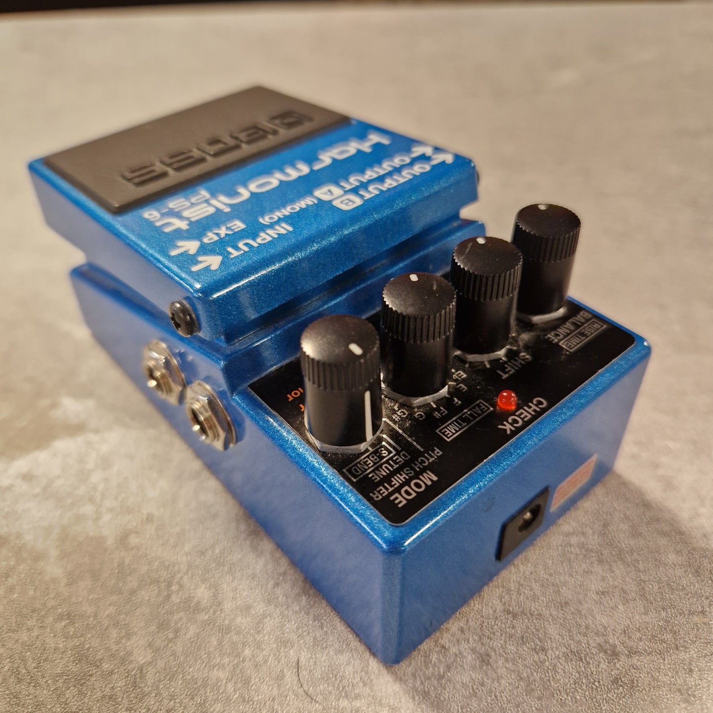 Pre-Owned Boss Blue guitar effects pedal with knobs and labels on a grey surface