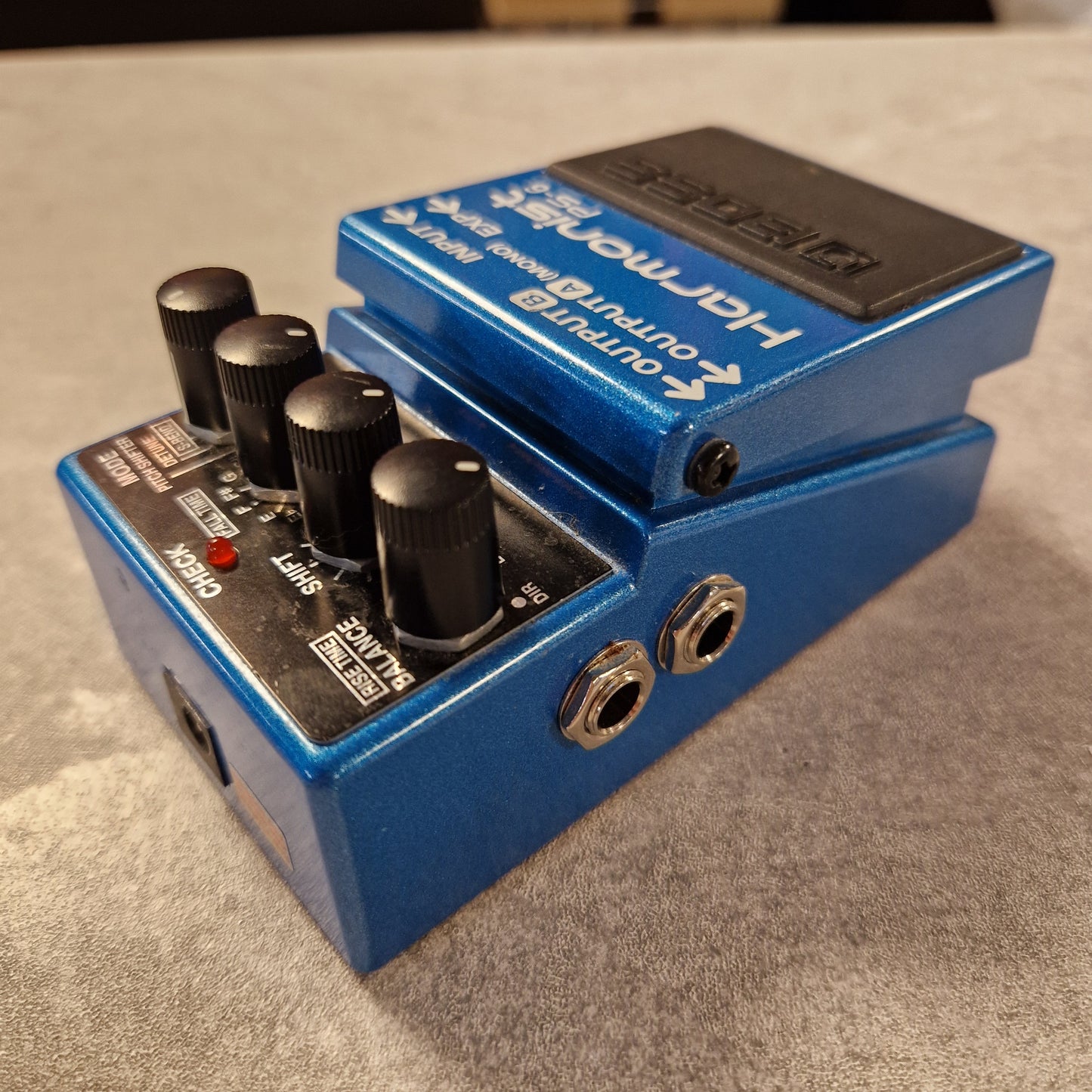 Pre-Owned Boss Blue guitar effects pedal with visible branding on a grey surface