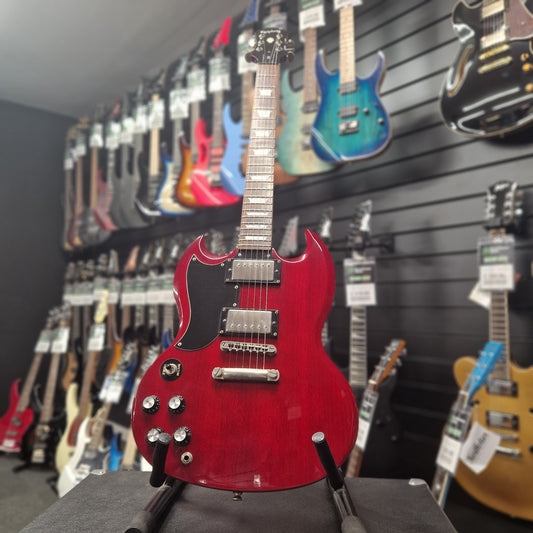Pre-Owned Epiphone Red electric guitar displayed in a music store with other guitars in the background
