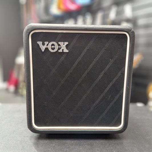 Pre-Owned Vox Black VOX amplifier with a blurred background