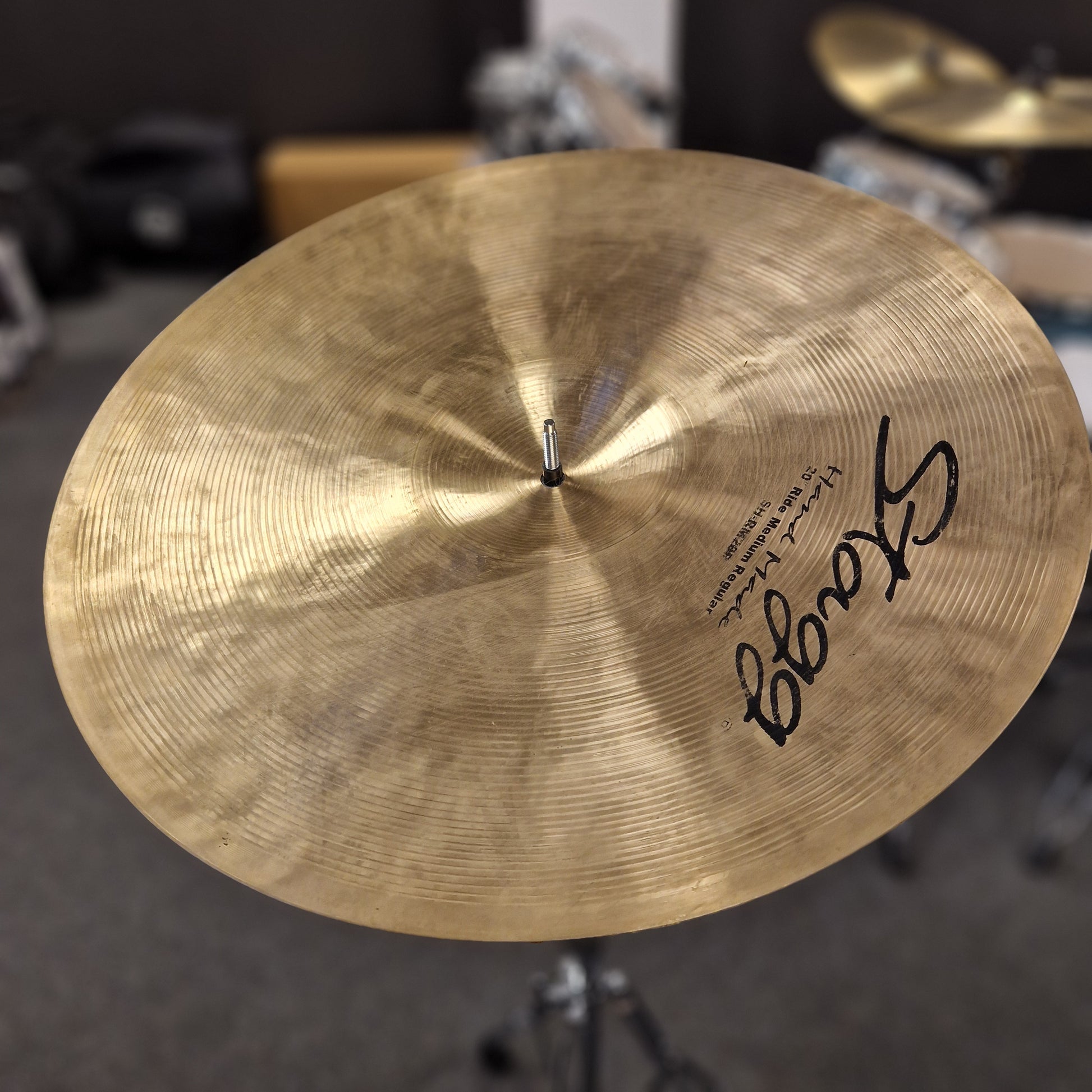 Pre-Owned Stagg Close-up of a Stagg cymbal with a blurred drum set background