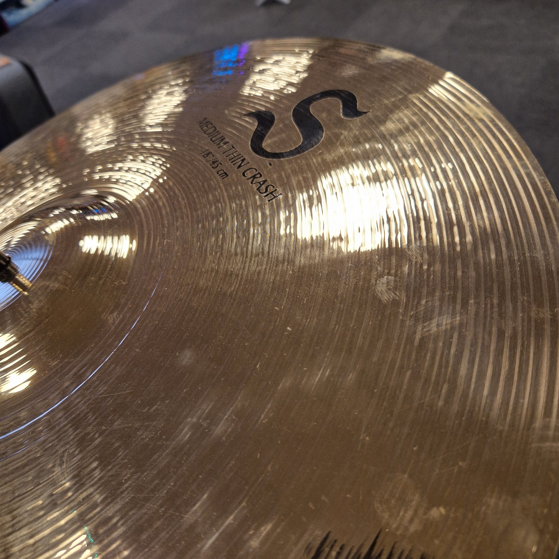 Pre-Owned Zildjian Close-up of a cymbal with 'S' logo and 'Crash' text on a blurred background
