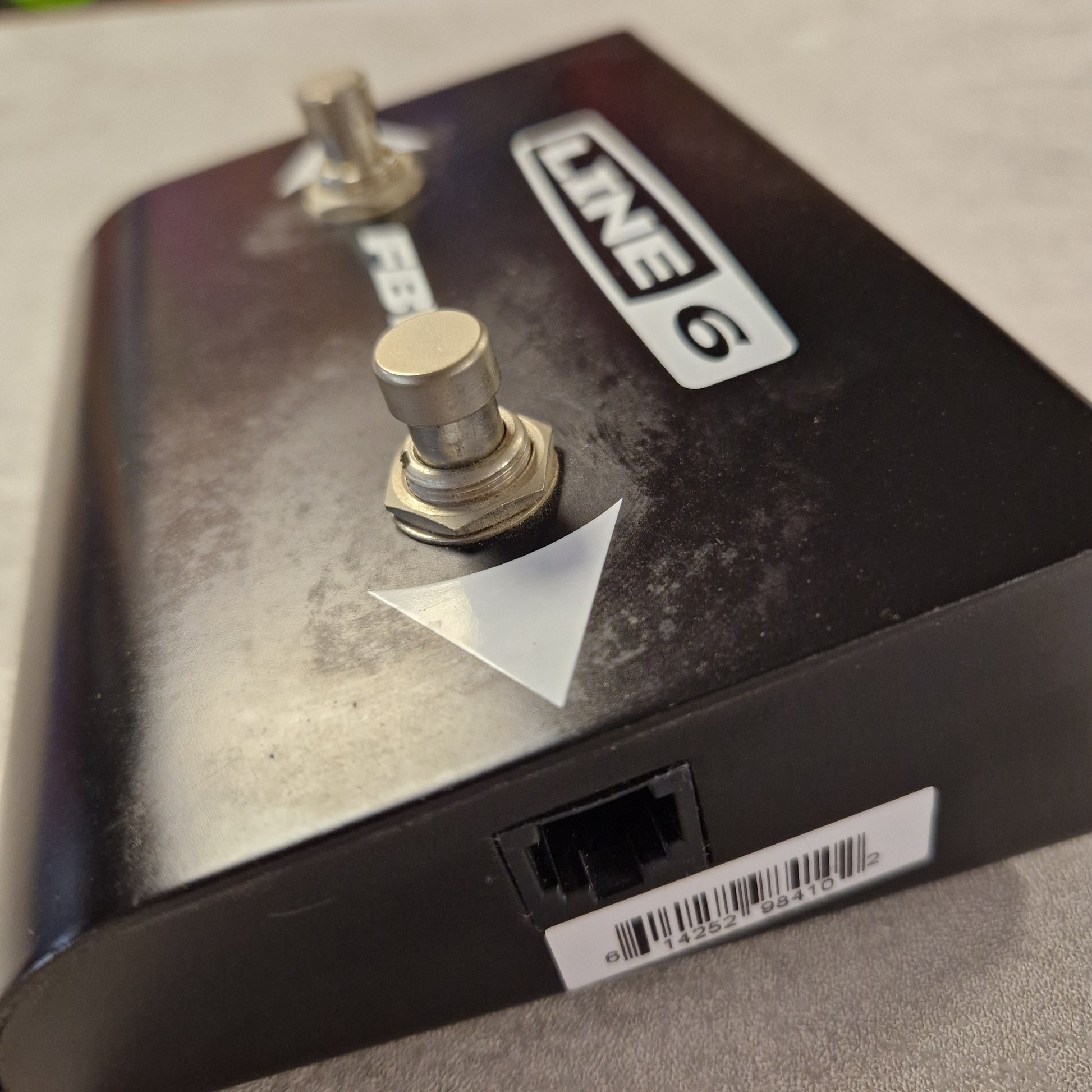 Pre-Owned Line 6 Close-up of a Line 6 device with a toggle switch and label.