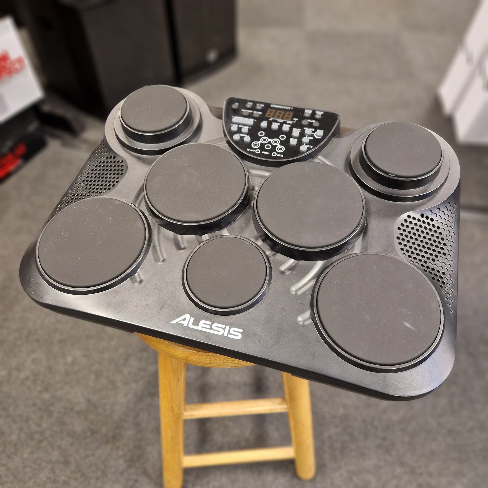 Pre-Owned Alesis Compact Kit 7 Alesis electronic drum pad on a blurred background