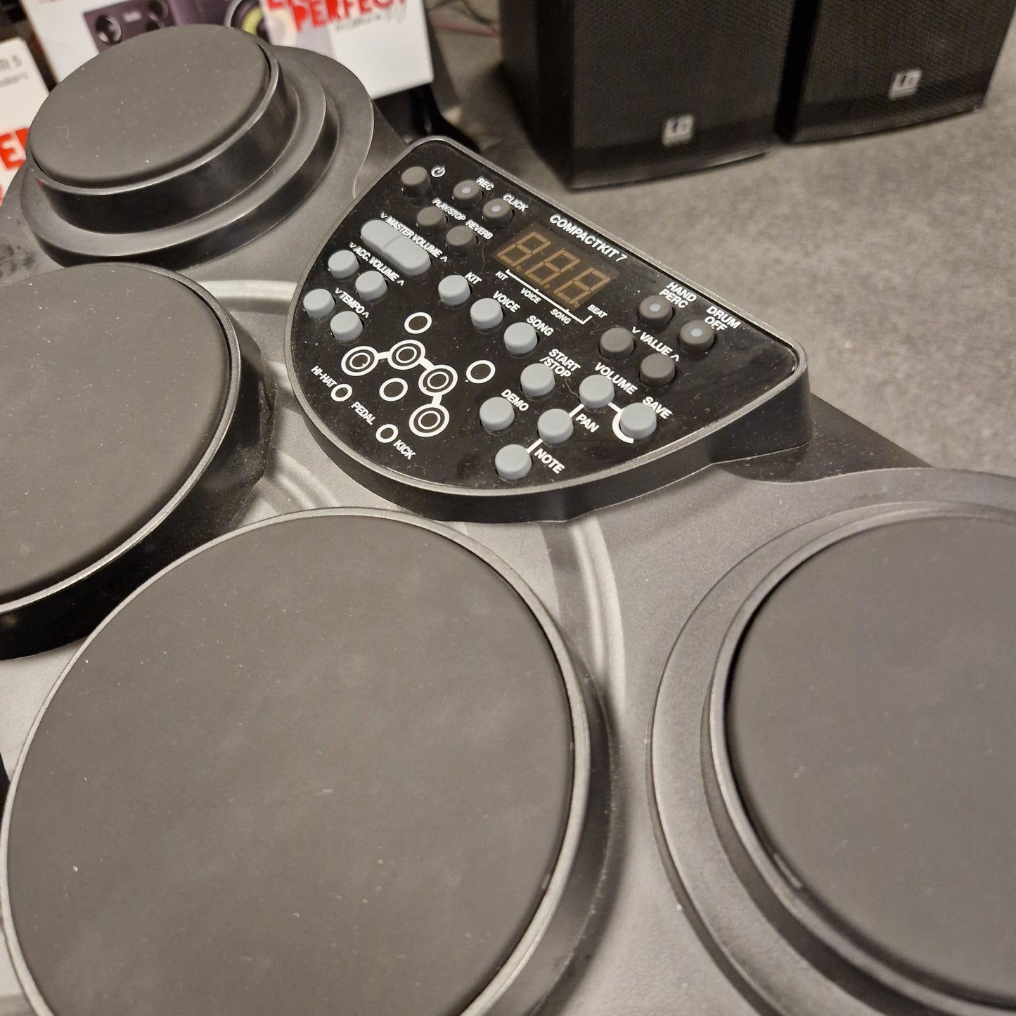 Pre-Owned Alesis Compact Kit 7 Electronic drum set with control panel on a grey surface