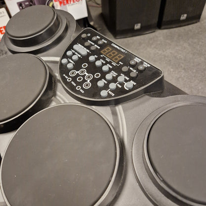 Pre-Owned Alesis Compact Kit 7 Electronic drum set with control panel on a grey surface