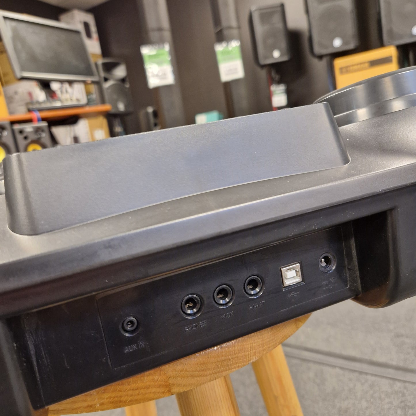 Pre-Owned Alesis Compact Kit 7 Close-up of a metallic door handle on a wooden chair with a blurred background.