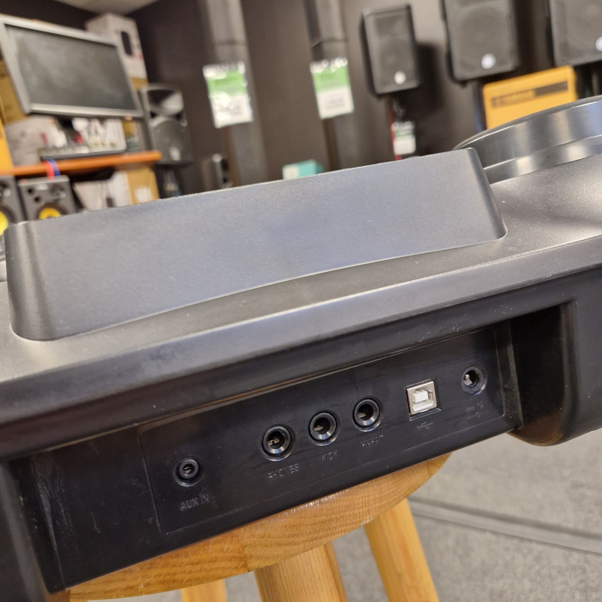 Pre-Owned Alesis Compact Kit 7 Close-up of a metallic door handle on a wooden chair with a blurred background.