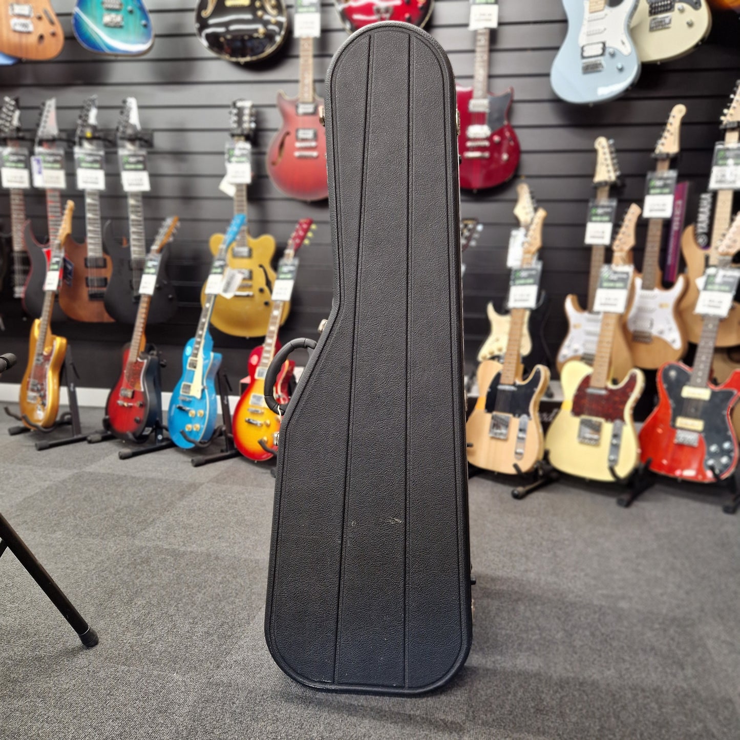 Pre-Owned Hiscox hard case on a blurry shop background