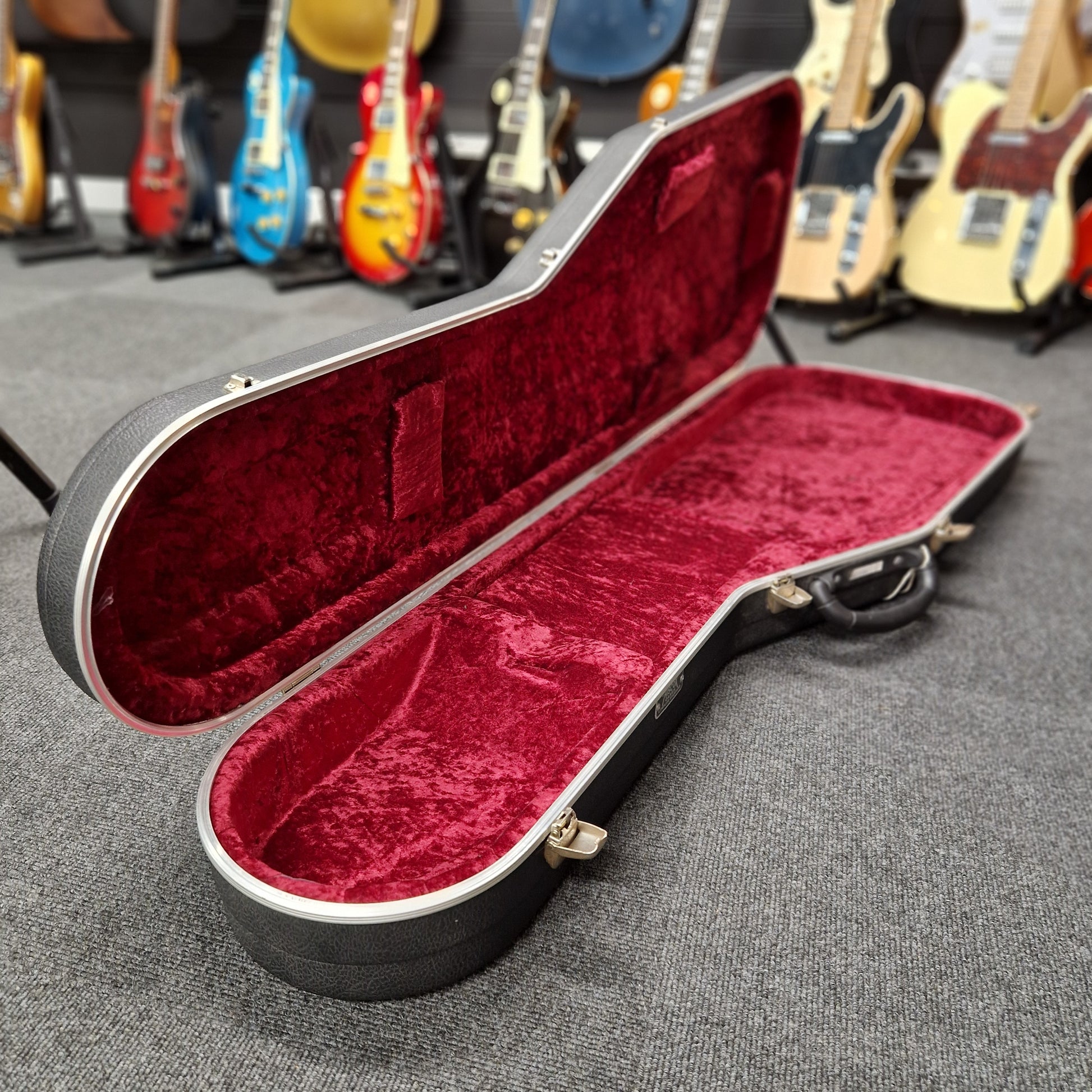 Pre-Owned Hiscox hard case on a blurry shop background