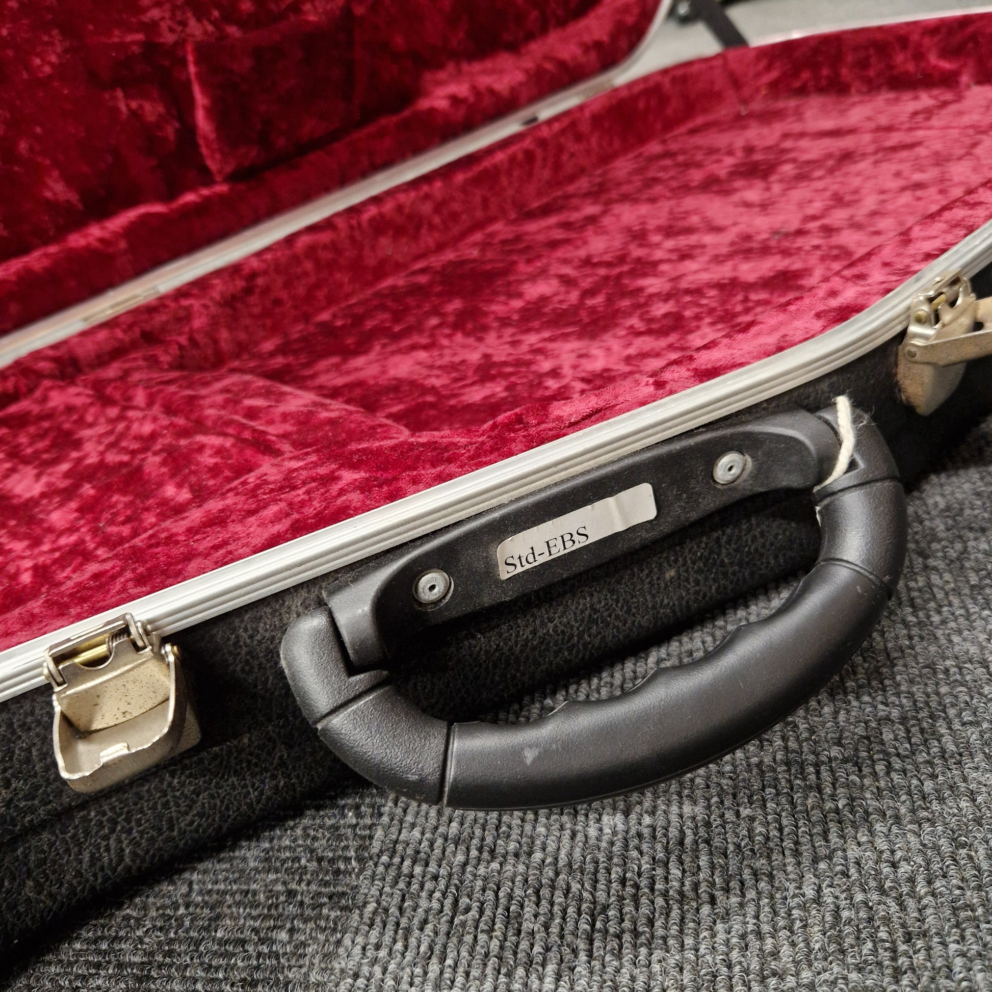 Pre-Owned Hiscox hard case on a blurry shop background