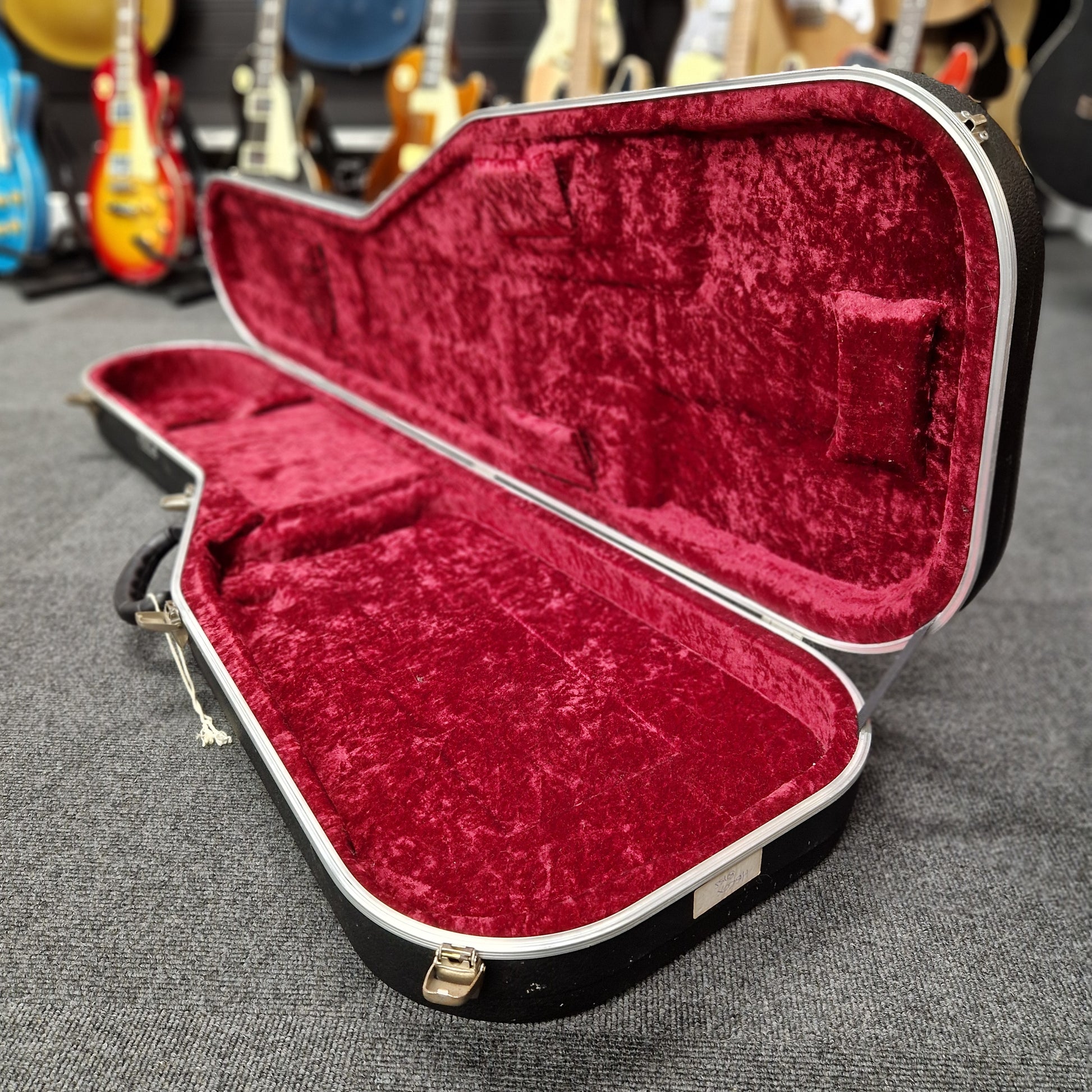 Pre-Owned Hiscox hard case on a blurry shop background