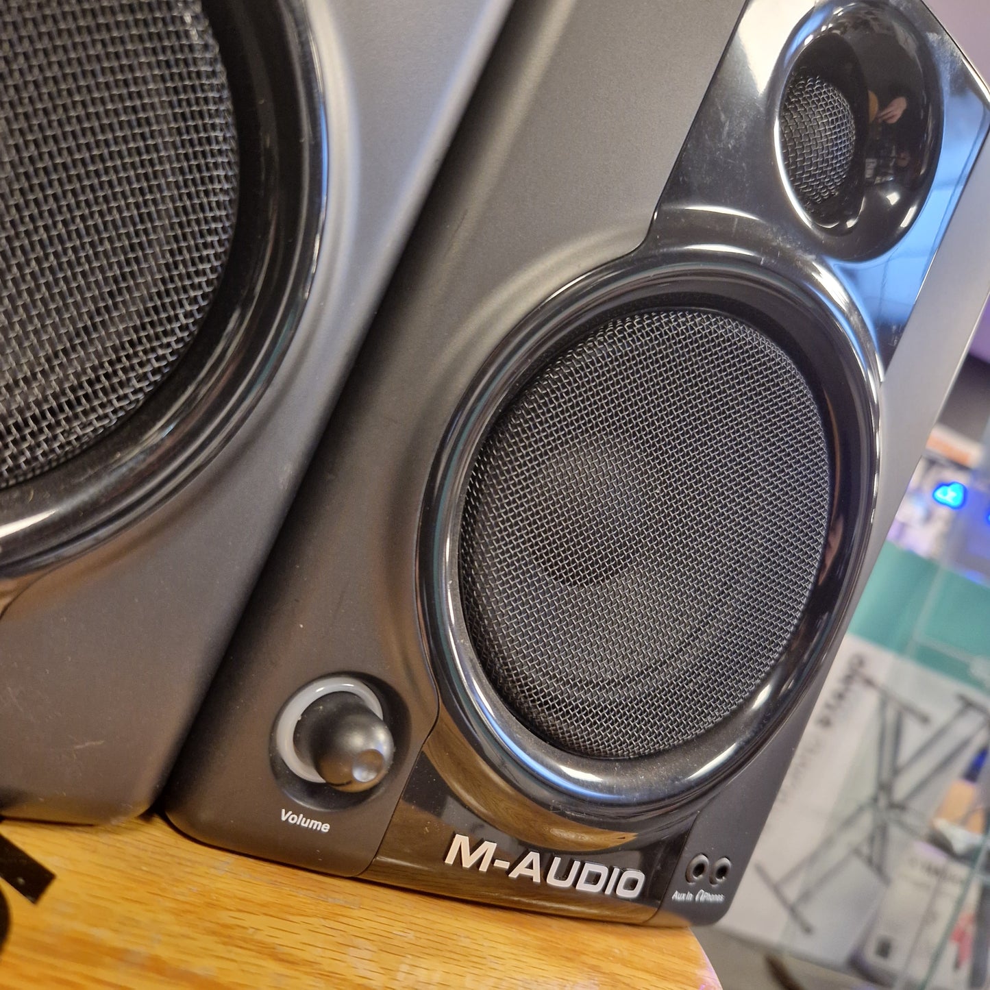 Pre-Owned M-Audio AV40 Studio Monitors Close-up of a M-Audio audio interface with speaker drivers on a wooden surface.