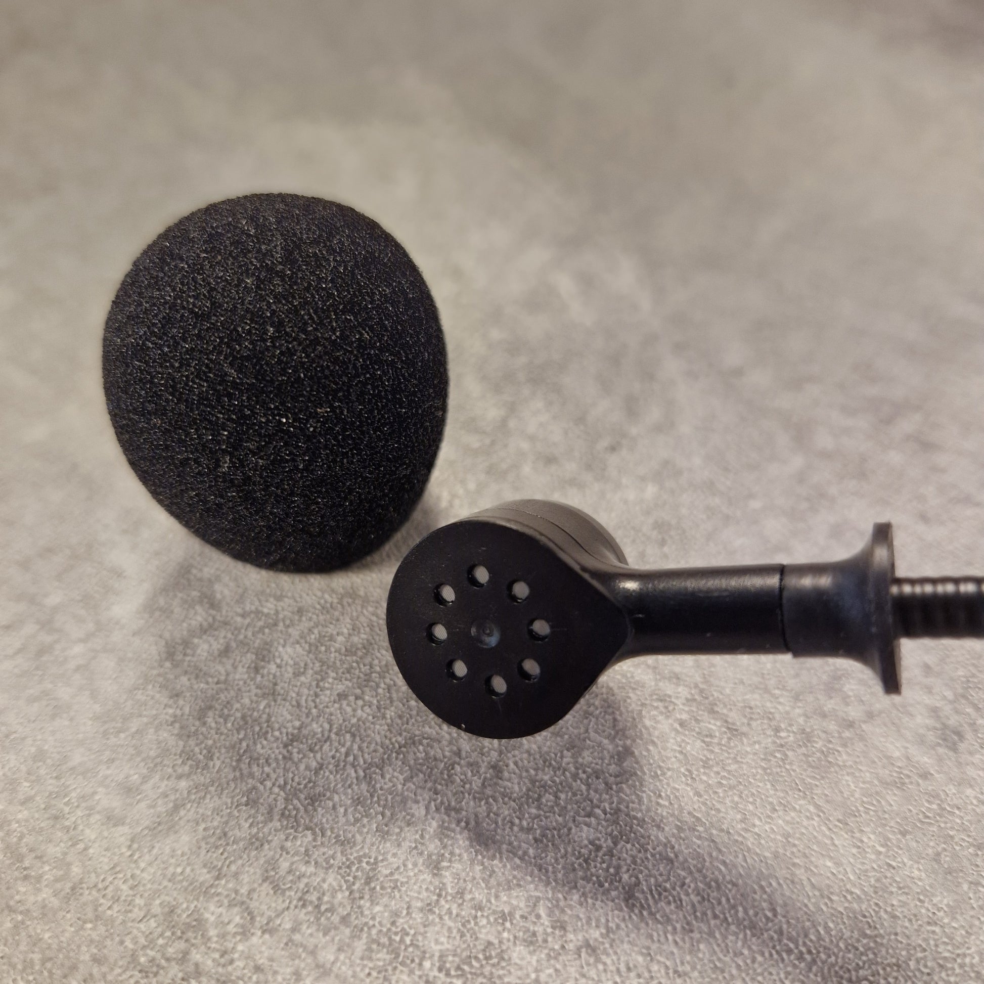 Pre-Owned Shure WH20XLR Headset Microphone - XLR Black shower head and nozzle on a textured grey background