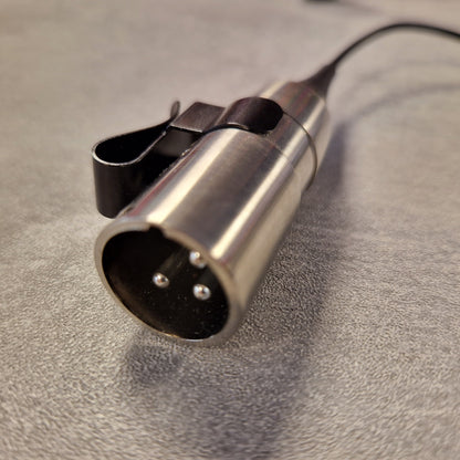 Pre-Owned Shure WH20XLR Headset Microphone - XLR Metallic microphone connector on a textured surface