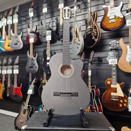 Pre-Owned Tanglewood EMETLCE Acoustic guitar displayed in a music store with other guitars in the background