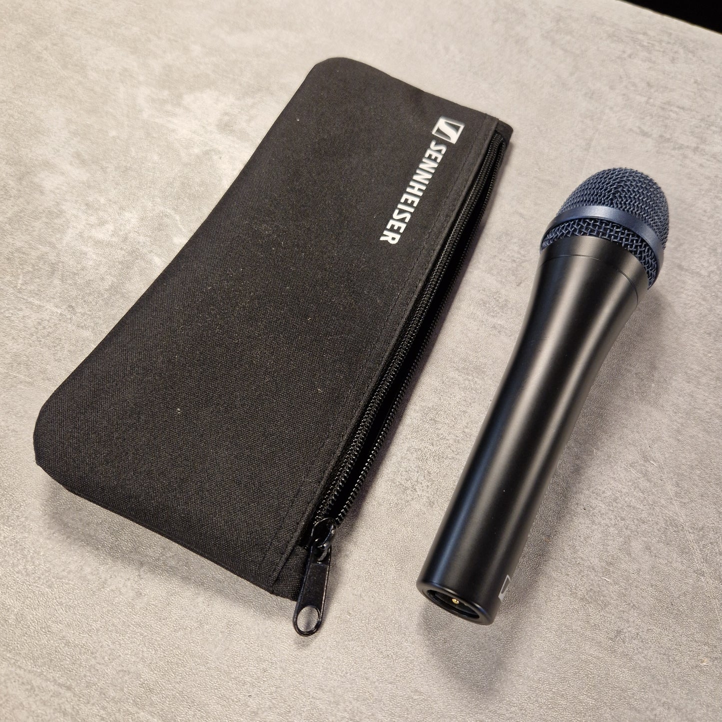 Pre-Owned Sennheiser E935 Sennheiser microphone and carrying case on a beige surface