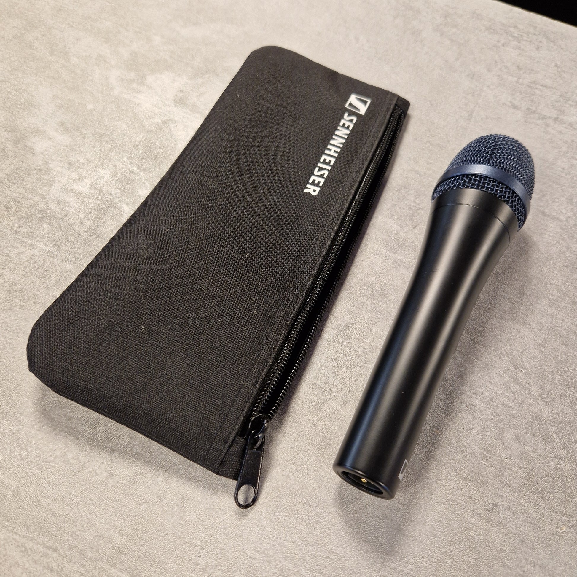 Pre-Owned Sennheiser E935 Sennheiser microphone and carrying case on a beige surface