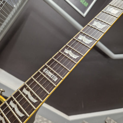 Pre-Owned ESP Close-up of a guitar neck with fretboard and tuning pegs against a blurred background