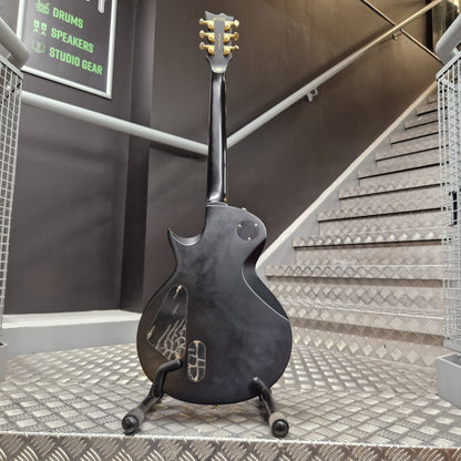 Pre-Owned ESP Electric guitar leaning against a wall in a recording studio.