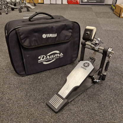 Pre-Owned Yamaha Yamaha drum hardware set with case on a gray floor