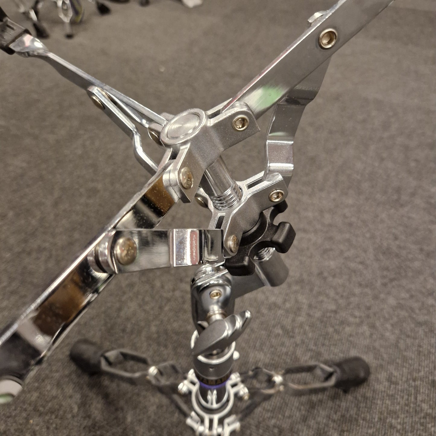 Pre-Owned Yamaha Close-up of a metallic drum pedal on a gray background