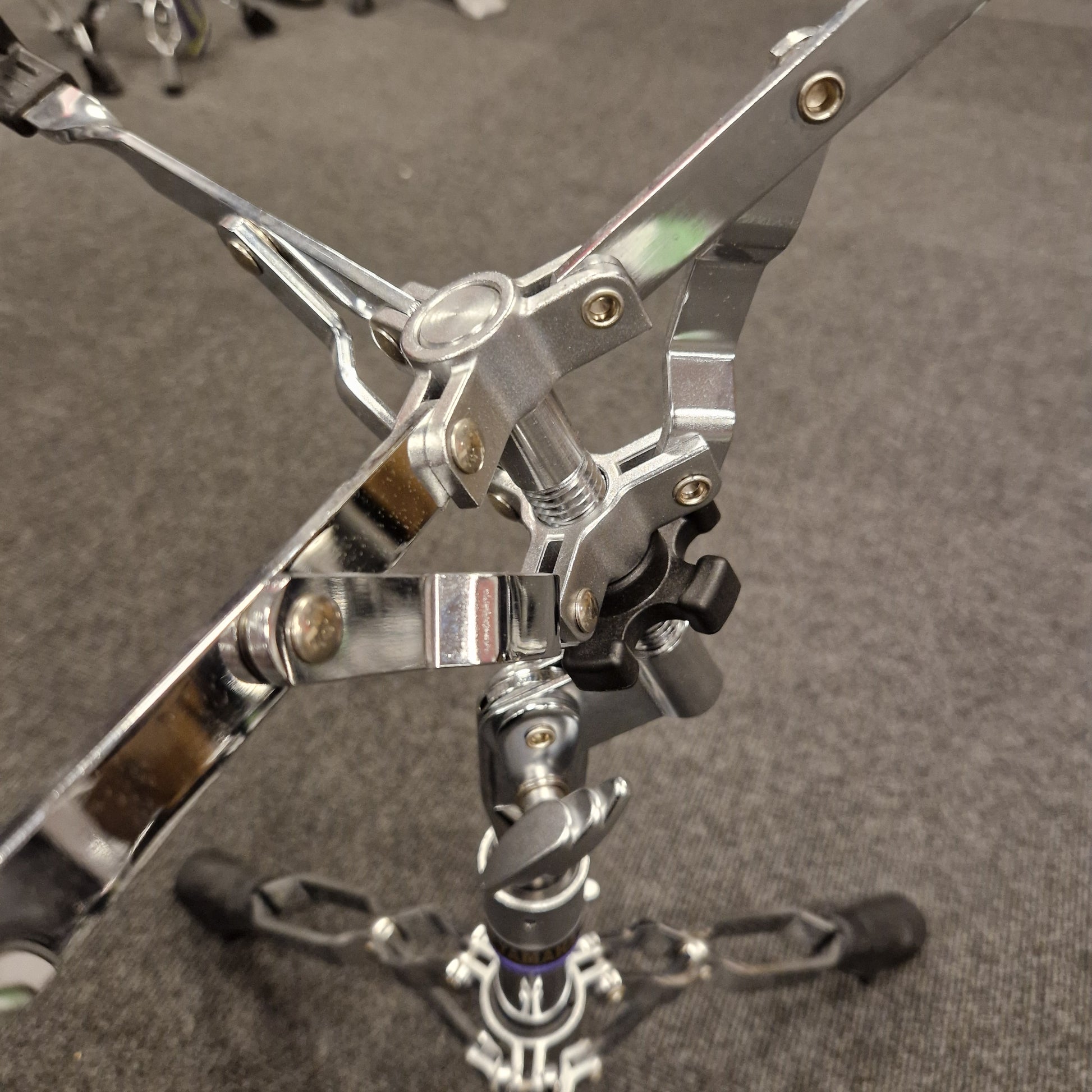 Pre-Owned Yamaha Close-up of a metallic drum pedal on a gray background