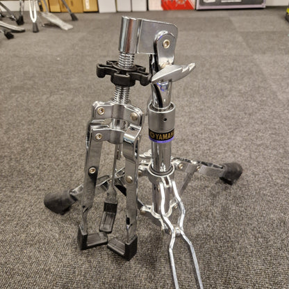 Pre-Owned Yamaha Close-up of a motorcycle foot peg and brake lever on a textured gray surface