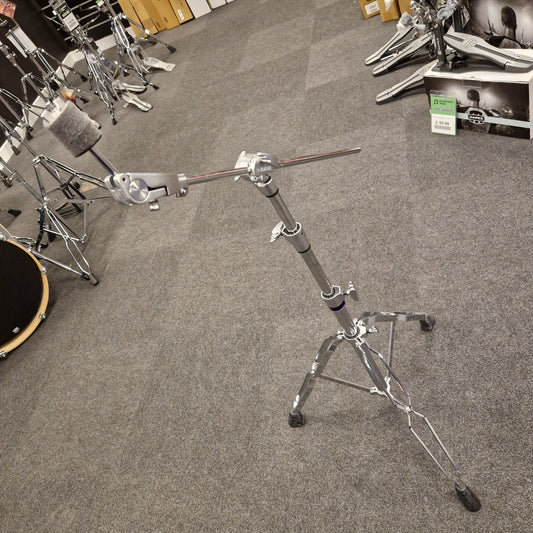 Pre-Owned Yamaha Drum stand on a gray carpeted floor with musical equipment in the background