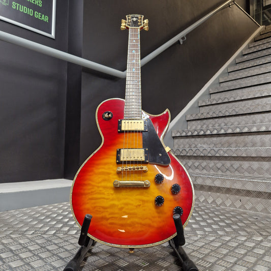 Pre-Owned Indie Electric guitar with a sunburst finish on a stand in a studio setting