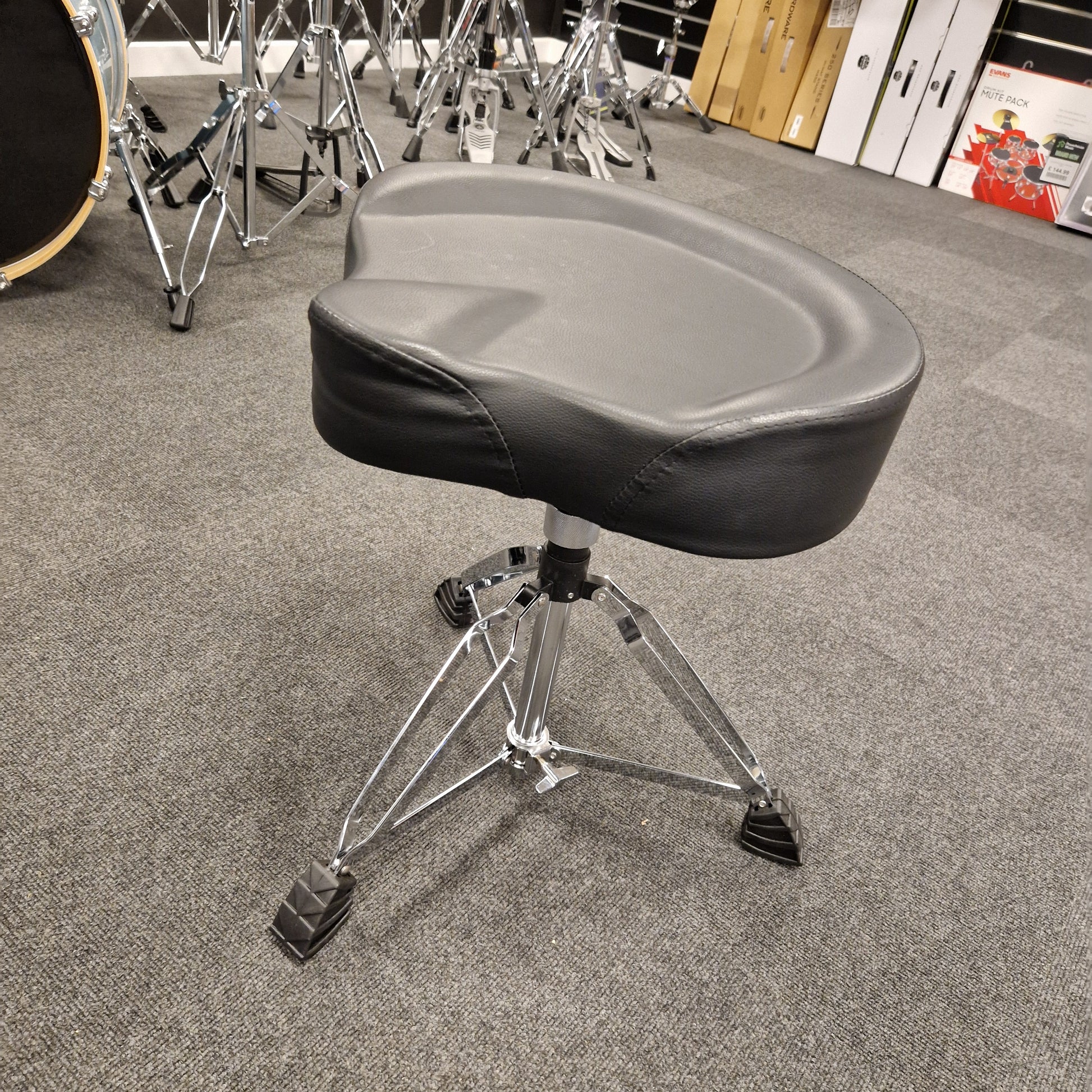 Pre-Owned Donner Drum throne with a gray cushion on a carpeted floor
