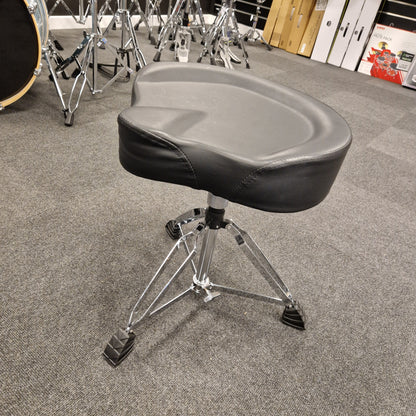 Pre-Owned Donner Drum throne with a gray cushion on a carpeted floor