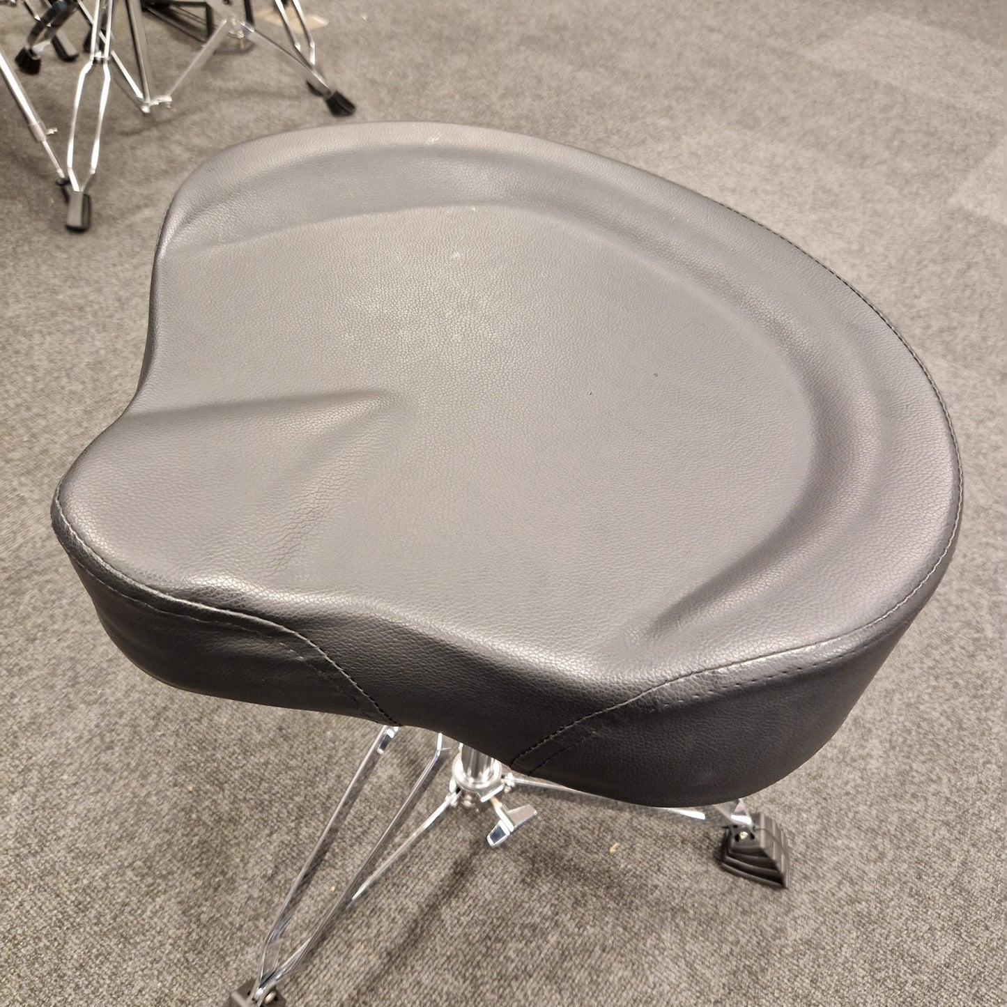 Pre-Owned Donner gray motorcycle seat on a stand against a neutral background