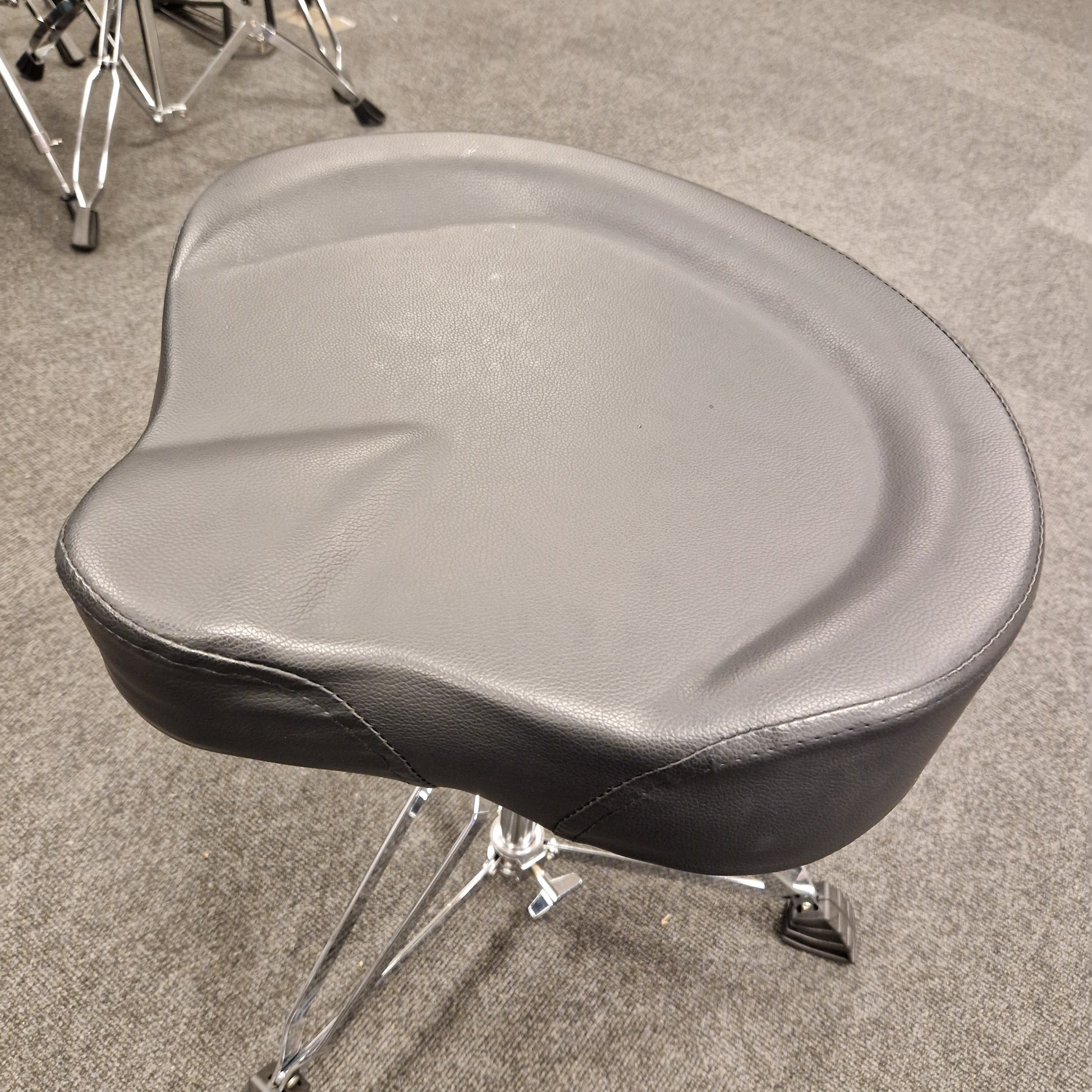 Pre-Owned Donner gray motorcycle seat on a stand against a neutral background